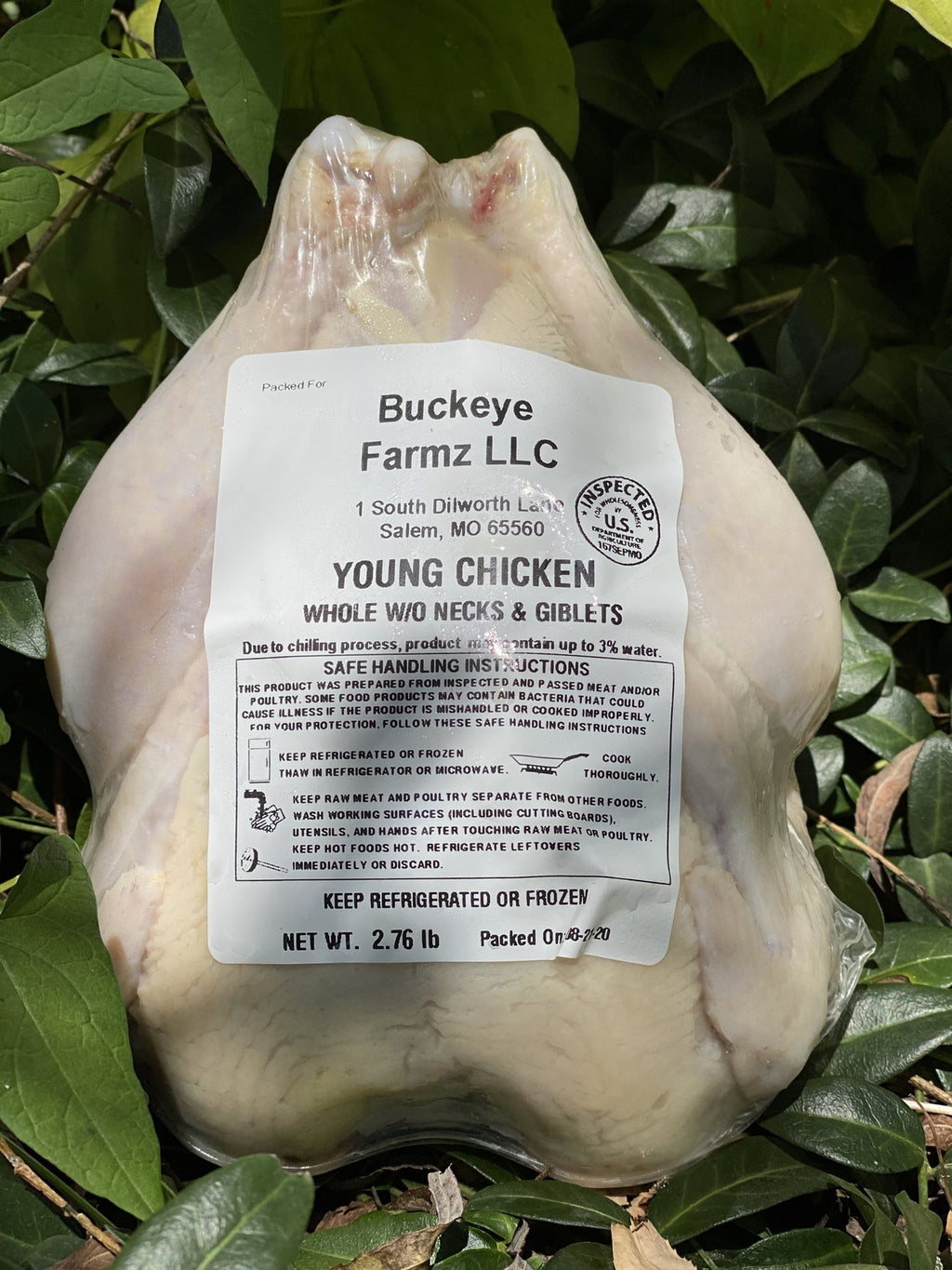 A whole young chicken in a labeled Buckeye FarmZ LLC package, packed at the farm in Salem, Missouri