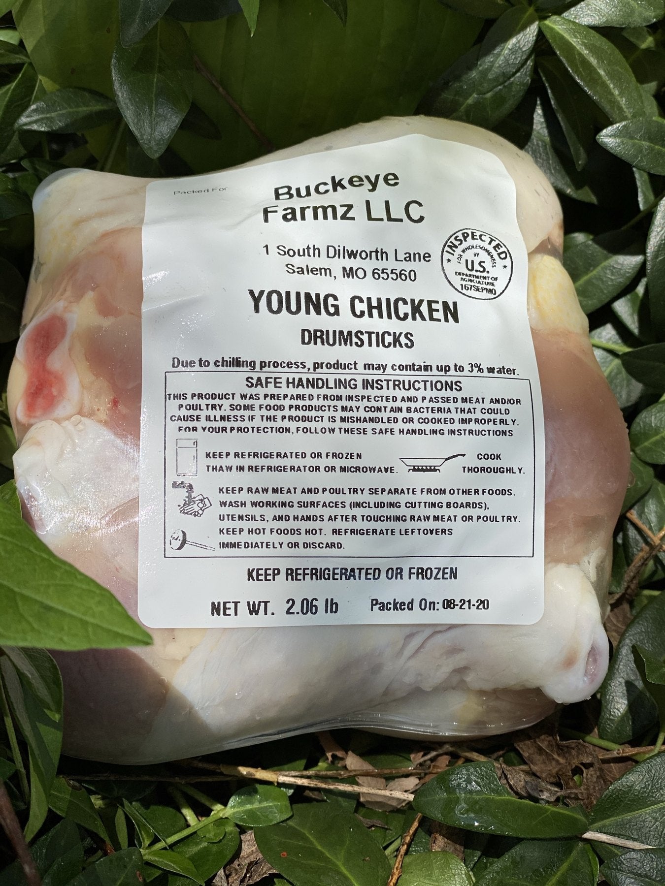 A labeled Buckeye FarmZ LLC package of young chicken drumsticks