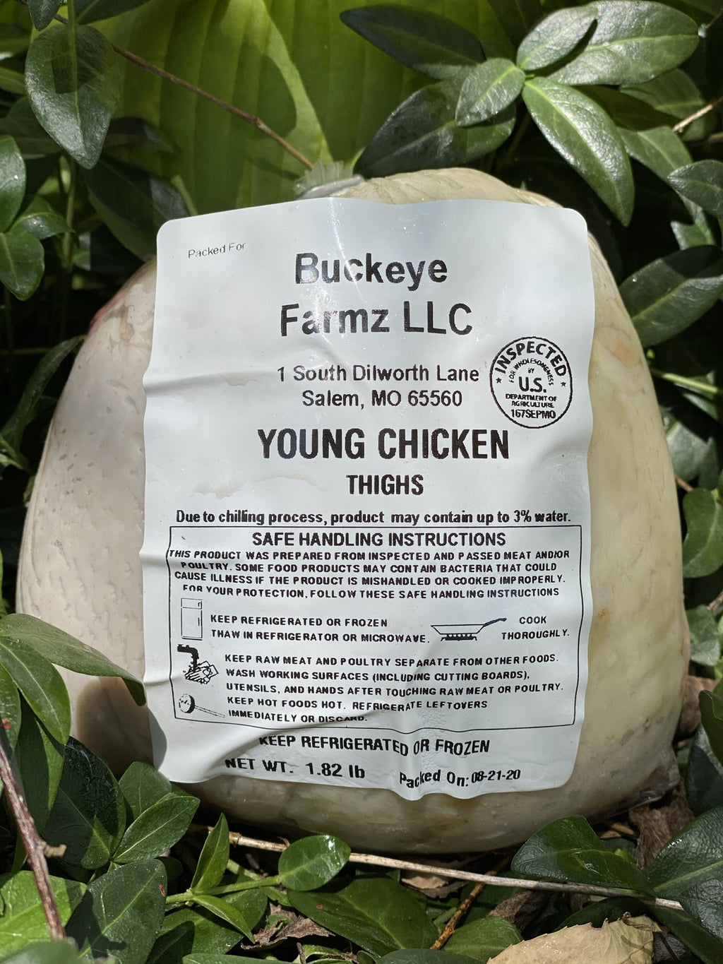 A labeled Buckeye FarmZ LLC package of young chicken thighs