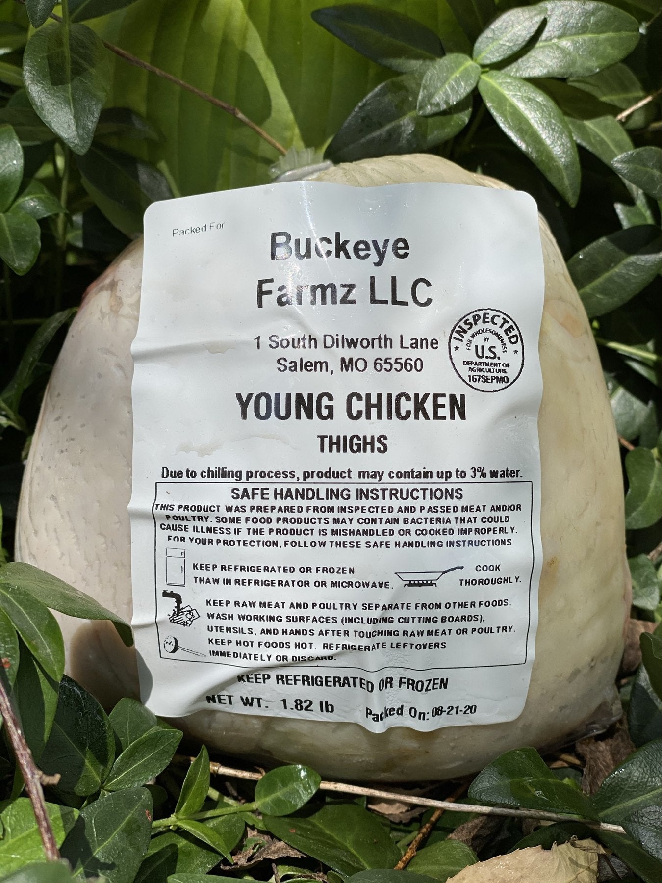 A labeled Buckeye FarmZ LLC package of young chicken thighs