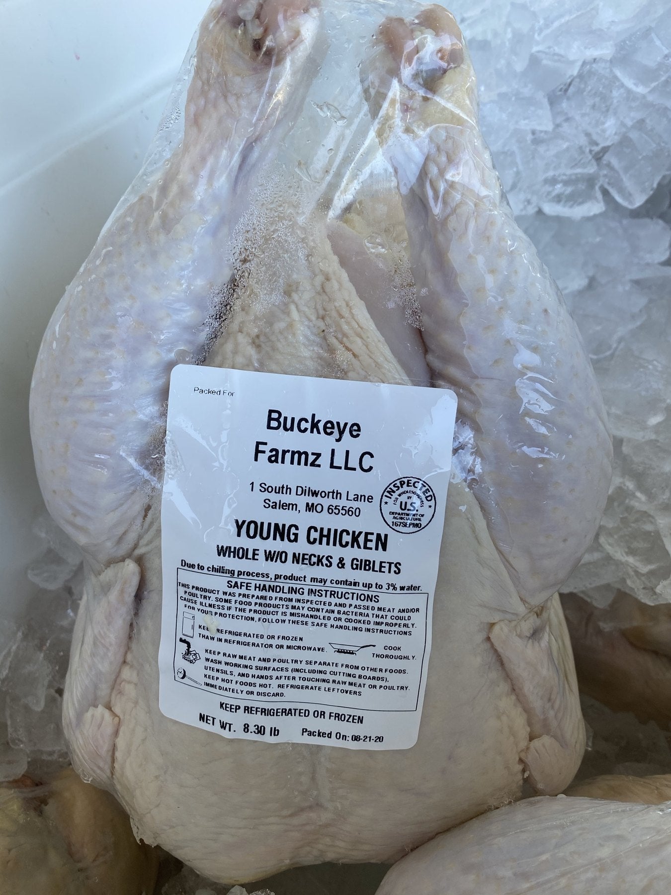 A whole young chicken in a labeled Buckeye FarmZ LLC package, packed at the farm in Salem, Missouri