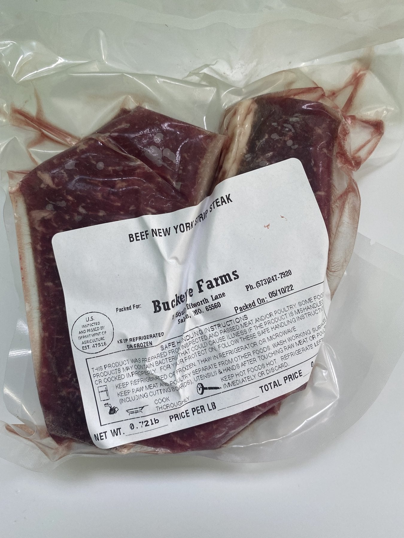 A labeled Buckeye Farms package of beef New York strip steak